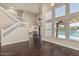 Open-concept living room featuring a staircase, hardwood floors, and backyard pool view at 1016 W Juanita Ave, Gilbert, AZ 85233