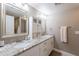 Bright bathroom features double vanity with granite countertops and framed mirrors and updated cabinets at 1217 N 78Th St, Scottsdale, AZ 85257