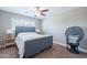 Cozy bedroom with a comfortable bed, ceiling fan, and a window providing natural light at 1217 N 78Th St, Scottsdale, AZ 85257