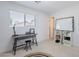 Bright, minimalist bedroom with a desk, whiteboard, and large window that provide ample light on neutral carpet at 1217 N 78Th St, Scottsdale, AZ 85257