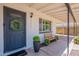 Inviting front porch with a charming bench, plants, and a wreath on the front door, creating a cozy entrance at 1217 N 78Th St, Scottsdale, AZ 85257