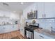 Well-lit kitchen with white cabinets, stainless steel appliances, granite countertops, and modern fixtures at 1217 N 78Th St, Scottsdale, AZ 85257
