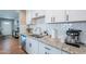 Bright kitchen showcasing white cabinetry, subway tile backsplash, stainless steel sink and granite countertops at 1217 N 78Th St, Scottsdale, AZ 85257