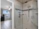 Bathroom with glass enclosed shower and view into bedroom at 12841 W W . Via Camille --, El Mirage, AZ 85335