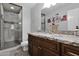 Bathroom featuring granite countertops, a glass enclosed shower, and wood cabinets at 12841 W W . Via Camille --, El Mirage, AZ 85335