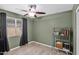 Bedroom with ceiling fan, dark curtains and tile floors at 12841 W W . Via Camille --, El Mirage, AZ 85335