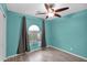 Bright bedroom with arched window, ceiling fan, and tile floors at 12841 W W . Via Camille --, El Mirage, AZ 85335