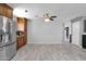 Open kitchen with stainless steel refrigerator, tile flooring and wooden cabinets at 12841 W W . Via Camille --, El Mirage, AZ 85335