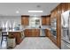 Spacious kitchen with custom cabinets, stainless steel appliances, granite countertops, and tile flooring at 12841 W W . Via Camille --, El Mirage, AZ 85335