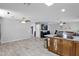 Open concept living room with TV, tile floors, and view into kitchen at 12841 W W . Via Camille --, El Mirage, AZ 85335