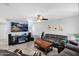 Open-concept living room featuring tile floors, ample natural light, ceiling fan, and tv at 12841 W W . Via Camille --, El Mirage, AZ 85335