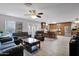 Open-concept living room and kitchen featuring tile floors, ample natural light, custom cabinets, and stainless appliances at 12841 W W . Via Camille --, El Mirage, AZ 85335