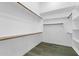 This walk-in closet provides ample shelving and wooden rods for storage solutions at 1487 E Laredo St, Chandler, AZ 85225