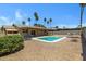 Inviting backyard featuring a refreshing pool, covered patio, and desert landscaping at 2305 E Glade Ave, Mesa, AZ 85204