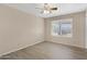 Well-lit bedroom with light colored walls, new flooring, and natural light at 2305 E Glade Ave, Mesa, AZ 85204