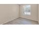 Cozy bedroom with light walls, new flooring and a window at 2305 E Glade Ave, Mesa, AZ 85204