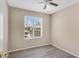 Bright bedroom with new flooring, a ceiling fan and natural light at 2305 E Glade Ave, Mesa, AZ 85204