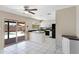 Eat-in kitchen with white cabinetry, black appliances, and sliding doors to the outdoor pool area at 2305 E Glade Ave, Mesa, AZ 85204