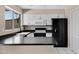 Updated kitchen with white cabinetry, black appliances, stylish faucet and ample counter space at 2305 E Glade Ave, Mesa, AZ 85204