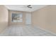 Cozy room featuring neutral paint, tile flooring, and a ceiling fan for comfortable living at 2305 E Glade Ave, Mesa, AZ 85204