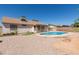 Home backyard with an above ground pool, desert landscaping, partial patio, and fencing at 2509 N Cheri Lynn Dr, Chandler, AZ 85225