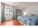Inviting bedroom with a large window, wood-look floors, and a ceiling fan at 2509 N Cheri Lynn Dr, Chandler, AZ 85225