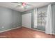 Simple bedroom with a window, closet, ceiling fan, and wood-look floors at 2509 N Cheri Lynn Dr, Chandler, AZ 85225