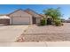 A charming single-story home with a well-maintained lawn and an attached two car garage, and desert landscaping at 2509 N Cheri Lynn Dr, Chandler, AZ 85225