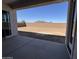 Large, empty backyard with potential for landscaping, featuring a concrete patio and mountain views at 26232 N 77Th Dr, Peoria, AZ 85383