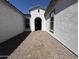 Inviting entrance showcasing a paved walkway leading to the front door and a charming covered porch at 26232 N 77Th Dr, Peoria, AZ 85383