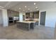 Open kitchen boasts a large center island, stainless steel appliances, and ample cabinet space, perfect for modern living at 26232 N 77Th Dr, Peoria, AZ 85383