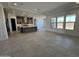 Bright, open living space with tile floors and large windows, flowing seamlessly into the kitchen at 26232 N 77Th Dr, Peoria, AZ 85383