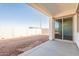 Spacious covered back patio with concrete flooring and sliding glass doors to the interior at 34865 N Palm Dr, San Tan Valley, AZ 85140