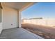 Covered back patio offers an extension of the home, with a view of the block wall and desert landscape at 34865 N Palm Dr, San Tan Valley, AZ 85140