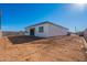 View of the home's back exterior and yard, showing block wall and windows at 34865 N Palm Dr, San Tan Valley, AZ 85140