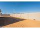 Expansive backyard showcasing block wall and potential for landscaping at 34865 N Palm Dr, San Tan Valley, AZ 85140