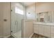 Bathroom featuring a glass shower, white cabinets, and a large mirror at 34865 N Palm Dr, San Tan Valley, AZ 85140