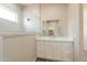 Bright bathroom features a sleek vanity, large mirror and walk-in shower with glass enclosure at 34865 N Palm Dr, San Tan Valley, AZ 85140