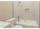 Bright bathroom features a shower/tub with white tiling and a built-in shelf at 34865 N Palm Dr, San Tan Valley, AZ 85140