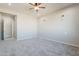 Spacious bedroom features neutral carpet, ceiling fan, and sconce lighting at 34865 N Palm Dr, San Tan Valley, AZ 85140