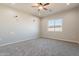 Bedroom with carpet and a window, complemented by modern lighting fixtures at 34865 N Palm Dr, San Tan Valley, AZ 85140