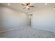 Bright bedroom with carpet, a ceiling fan, and an open doorway at 34865 N Palm Dr, San Tan Valley, AZ 85140