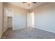 Spacious bedroom features neutral carpet, ceiling fan, and direct access to the walk-in closet at 34865 N Palm Dr, San Tan Valley, AZ 85140