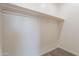 A bright walk-in closet features a wooden hanging bar and neutral carpet at 34865 N Palm Dr, San Tan Valley, AZ 85140
