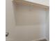 An organized, bright walk-in closet features a wooden hanging bar and neutral carpet at 34865 N Palm Dr, San Tan Valley, AZ 85140
