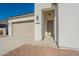 Close up of a charming single-story home with desert landscaping and a two-car garage at 34865 N Palm Dr, San Tan Valley, AZ 85140