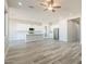 Bright, open-concept kitchen featuring white cabinets, stainless steel appliances, and a large island at 34865 N Palm Dr, San Tan Valley, AZ 85140
