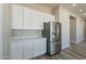 Bright kitchen features white cabinets, stainless steel appliances, and solid countertops at 34865 N Palm Dr, San Tan Valley, AZ 85140