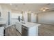 Open concept kitchen features an island with a stainless dishwasher and a view of an adjacent living space at 34865 N Palm Dr, San Tan Valley, AZ 85140