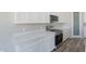 Bright kitchen features white cabinets, stainless steel appliances, solid countertops, and a walk-in pantry at 34865 N Palm Dr, San Tan Valley, AZ 85140